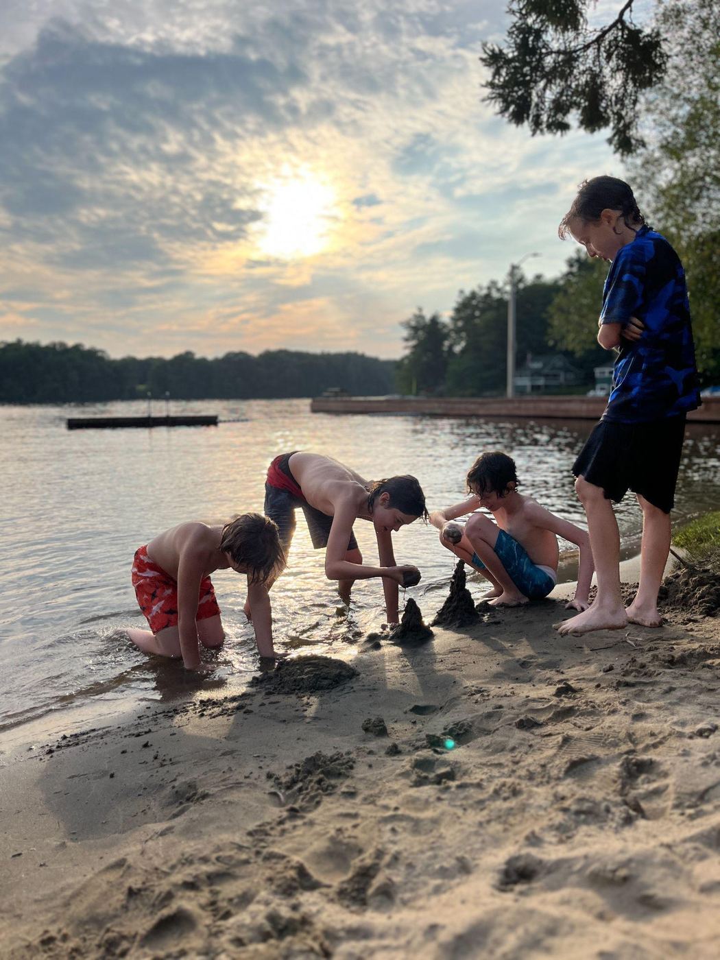 The boys playing at the lake's edge on a summer evening in Muskoka